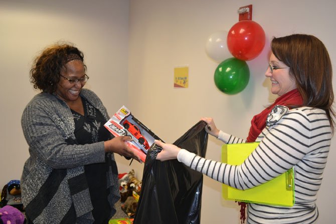 Education coordinator Krista Sofonia (right) helps an inmate’s family member as she selects gifts.