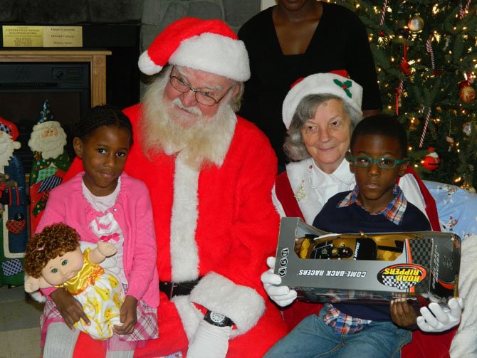 The Easter Seals Respite Program makes Saturdays a brighter for families like the Heywards. Imani, 4, and Jeremy, 6, pose with Santa and Mrs. Claus.