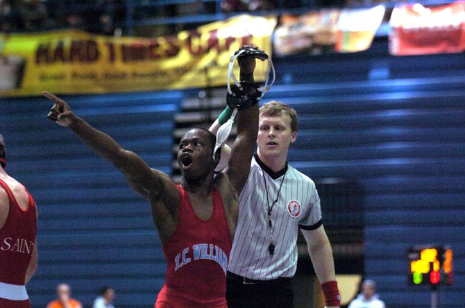 T.C. Williams senior Ibrahim Bunduka acknowledges the crowd after winning the 126-pound title at the NOVA Classic wrestling tournament on Dec. 8 at Fairfax High School.