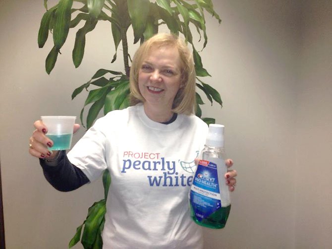 Margery Leveen Sher, executive director of the Medical Care for Children Partnership Foundation, raises a toast to children’s dental health as the foundation launches Project Pearly Whites to raise $24,000 by the end of the year to provide dental care for 40 children.  