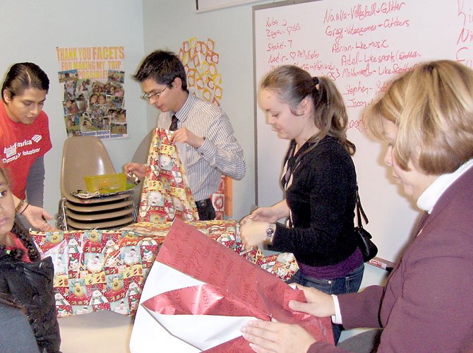 Bank of America volunteers wrapping presents are (from left) Amilcar Ferrufino, Mauricio Matallana, Carmen Berdea and Maria Sorto.