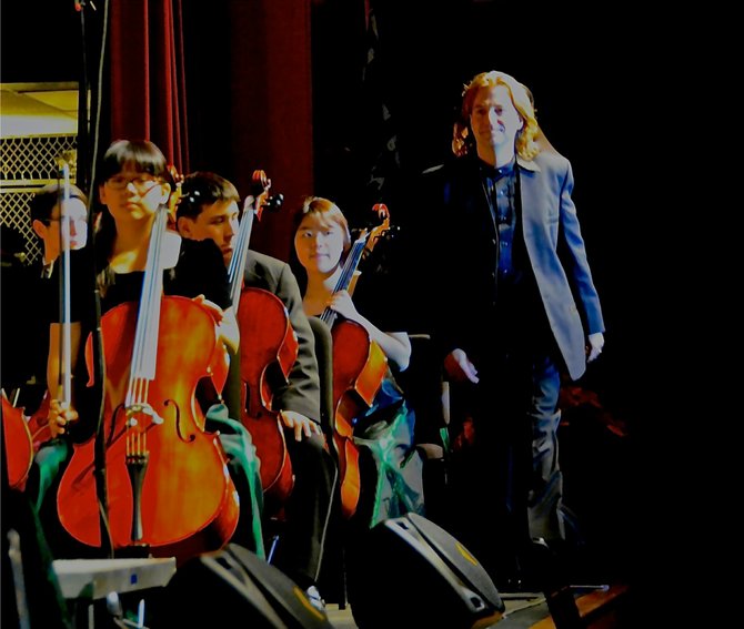 Guest Conductor Glenn Quader prepares to conduct the Langley HS Orchestra.