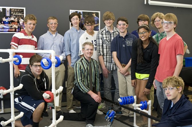 Robotics Team (from left): Scott Hamal, Malek Zahed, (kneeling), Jonny Howard, Evan Wilcox, Head Coach Michael Snyder (kneeling), Ian Schmidt, Christopher Salmon, Brian Clark, Nick Cerruti, Tanvi Bansal, (in front of Nick), Sky Leonard, Thomas Briggs, Cooper Overholt (lower right corner).
