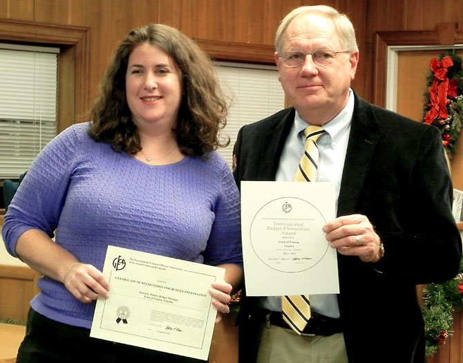 Gwen Riddle, budget manager, and Phil Grant, former finance director, receive the Certificate of Recognition for Budget Presentation at the Dec. 3 Town Council meeting.