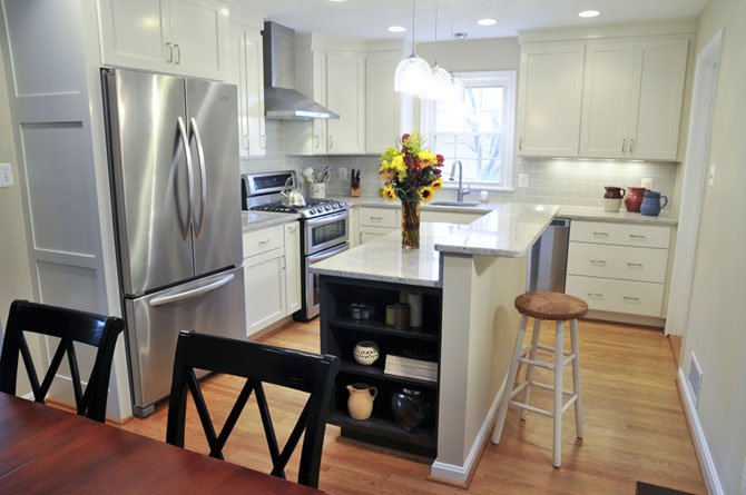 In the new kitchen, a mid-room island provides for a food preparation surface and a dining counter.