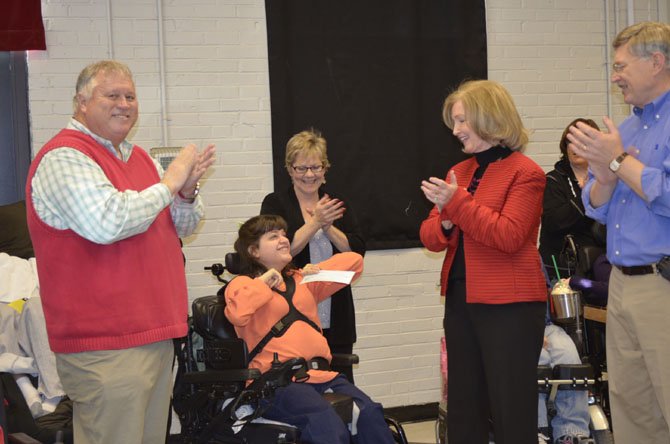Members of the Specially Adapted Resource Club, which provides opportunities for adults with disabilities, receive a $15,000 grant from Life Circle Alliances Dec. 14. SPARC has a location at the Old Firehouse Teen Center in McLean and the Southgate Community Center in Reston. 