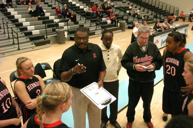 First-year Herndon head girls’ basketball coach Otto Jette speaks to his players during a game against Centreville on Jan. 7.