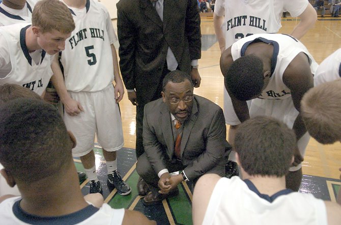 Flint Hill boys’ basketball coach Rico Reed speaks to the Huskies during a Jan. 5 contest against Bishop Ireton.