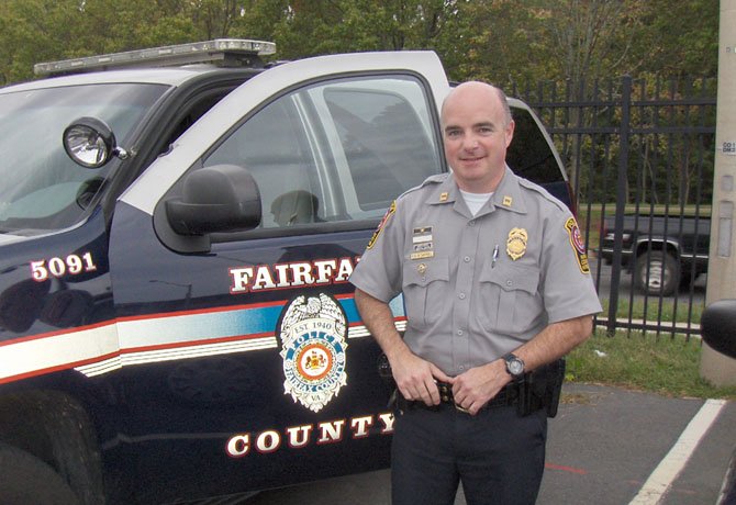 Capt. Ed O’Carroll stands by his police vehicle after work.