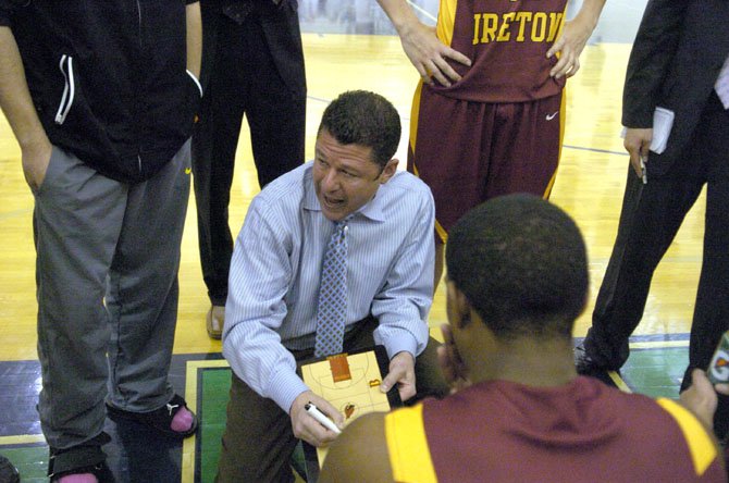 Bishop Ireton boys’ basketball coach Neil Berkman talks to the Cardinals during a game against Flint Hill on Jan. 5.