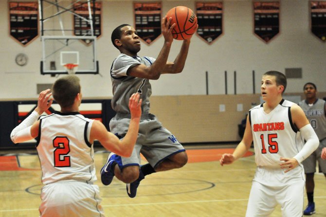 West Potomac point guard Brandon Pressley goes up for a shot against West Springfield on Jan. 8.