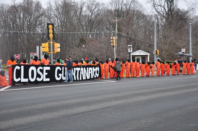 Hooded members of Witness Against Torture block the front entrance to CIA Headquarters Saturday, Jan. 12, to protest the agency’s use of torture and drone attacks. 