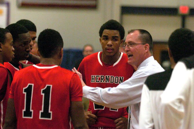 Herndon boys’ basketball coach Gary Hall speaks to the Hornets during a Jan. 10 game at Chantilly.