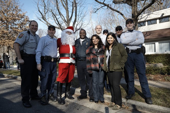 Santa and the West Springfield District Police Station joined with members of the Green Hills community on Saturday, Dec. 15, to share some holiday spirit and celebrate the progress the community has made with police help towards becoming safer after shootings and drug related occurrences over the past year. (From left, back row) MPO J.T. Frey, Lt. Jim Tanler, Santa (PFC Tom Champ), Captain Joe Hill, PFC Nate Vanhusen, PFC Rex Pagerie, PFC Rob Asencios, Ryan Quarto and two Green Hills community members.
