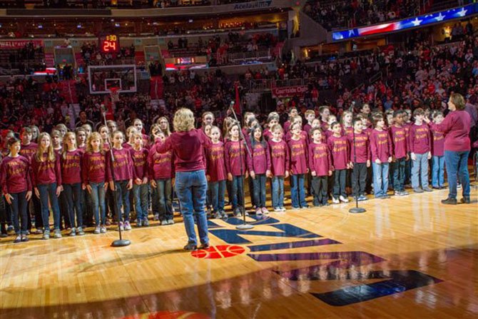 Chorus Directors Deborah Rudd and Marilyn Harwood during the Jan. 12 performance at the opening of the Wizards basketball game (vs. the Atlanta Hawks). The 70-member chorus filled the 20,000-seat arena with the sweet sounds of the National Anthem.