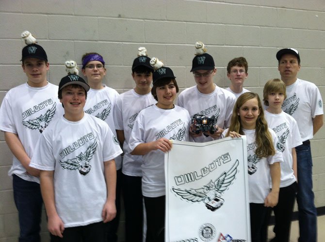 Owlbots: Front row, from left, are JD McLean, Anthony Mahshigian, Winston Grenier (with robot), Sarah Bash and Darius Kuddo. Back row, from left, are Chris McCormick, Jonah Barron, Noah Montemarano, Jack Wenger and Coach Jeff Oosterhout.