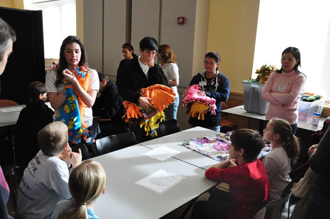 Maddie Pelgrim, a sophomore at Oakton High School and founder of Maddie’s Blankets, leads a briefing during a volunteer event. 