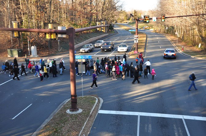 The commemorative march to honor Martin Luther King crosses Wiehle Avenue on its way to the Northern Virginia Hebrew Congregation Sunday, Jan. 20. 