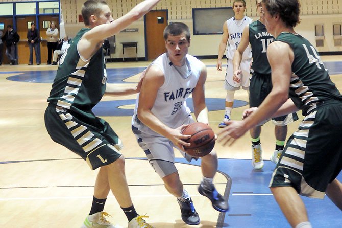 Langley’s Xavier Ryan, left, and Brad Dotson, right, defend against Fairfax’s John Robic on Jan. 26 at Fairfax High School.