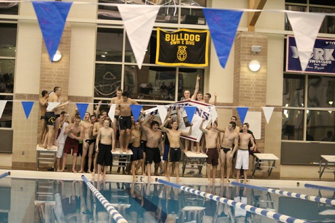 The Oakton High boys' team poses with the Concorde District banner after winning the championship meet.

