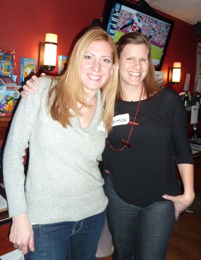 Jacki Donovan and Maj. Amanda Harrignton, board members of the Noble Argus Foundation, celebrate at a fundraiser Jan. 18 at The Light Horse restaurant. The organization provides scholarships and relief to families of Special Operations service members.