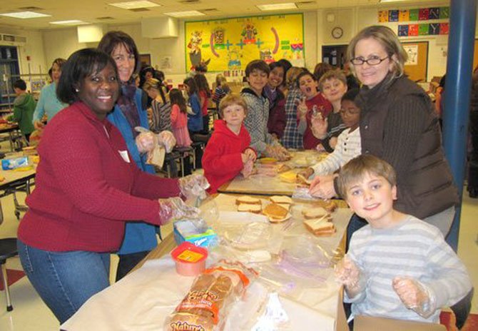 Churchill Road students and parents made sandwiches for Martha’s Table, a non-profit organization which serves food to those in need. Pictured from left are Kelly Khan, Lauri Dacey, Barney Smithers, James Murray, Mariano Olsen-Fappiano, Ethan Carlisle, Jackson Khan, Laura Carlisle and Luke Carlisle.