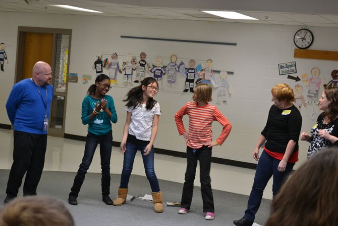 Theater Director Rebecca Holderness, Madeline Muravchik, and Danny Seagraves watch as Yusra Samaila, Jane Park, and Olivia Lewis start one of the storytelling exercises.