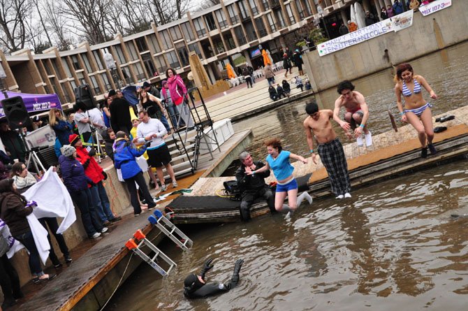 Onlookers watch jumpers hit the 35-degree waters of Lake Anne Saturday, Feb. 2, 2013, part of the annual fundraiser for Camp Sunshine.
