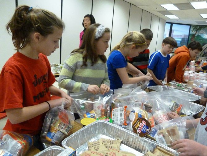 A hustling group of Union Mill fifth graders managed to assemble 248 weekend meal-packs or "Weekend Power Packs" for hungry children in the county.