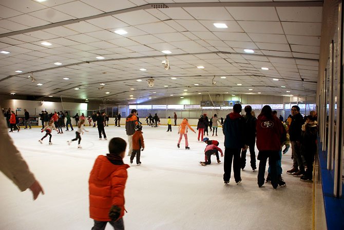 Men, women and children work up Super Bowl appetites skating around the rink at Fairfax Ice Arena.