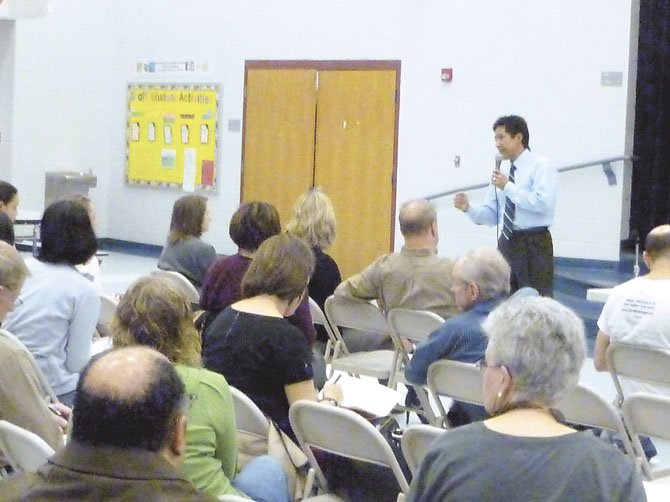 Chair of the Arlington County Board Walter Tejada answers questions from Arlington residents at Drew Community Center.