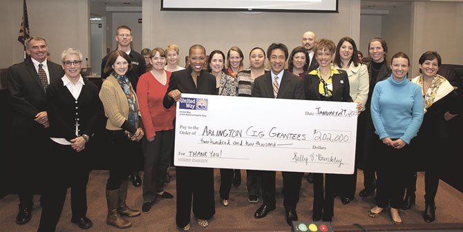 Holding the check from left is United Way NCA Chief Operating Officer Kelly Brinkley, Arlington County Board of Supervisors Chair Walter Tejada, and United Way NCA Arlington Regional Council Chair Leah Wallace. They are surrounded by the Arlington Community Impact Fund grantees.  