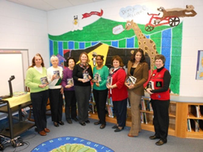 From left: Kimberley Harris Granahan, CRW past president; Kathleen Chevalier, recording secretary; Deborah Bodlander, 2012 CRW president; Lauren Sheehy, Hybla Valley Elementary School principal; Denise Pinchback, school librarian; Marguerite Saitta, assisant principal; Christina Schinner; Barbara Bush Literacy Project chair, and Lorraine Boyd, CRW corresponding cecretary.