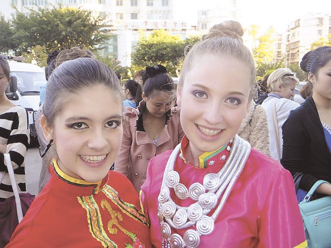 Sofia Falçao from Portugal and Molly Reiner of Potomac wear their costumes before the televised taping of the closing ceremony in China. 