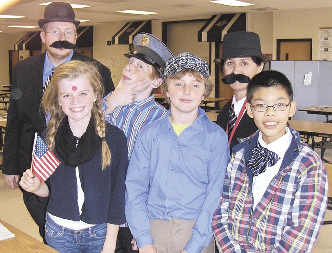 Back row, from left, are history teacher Dan Vroman, “Scottish policeman” Ryan Morris and history teacher Jeanne Costello; (front row, from left) are “Greek immigrants” Annie Davis, Jared Brennan and Shaun Wu. 