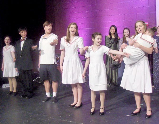 Performing as the Von Trapp children are (from left) Grace Shields, Marc Manaloto, Dimitri Gann, Aubrey Cervarich, Maya Tischler and Robinson student Carys Meyer, holding Dorothy Cervarich.