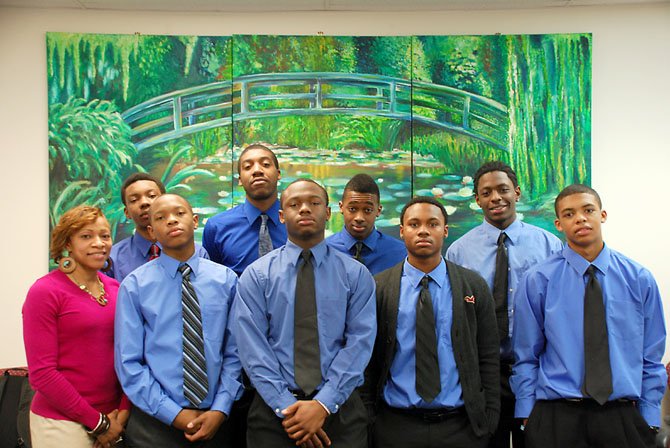 Lee social worker Marcella Fulmore is joined by PAAMAS members (bottom, from left) seniors Thomas Watson, Ashwin Pitt, Demond Richeson, sophomore Darryl Gray, (top, from left) seniors Pearson Wheatley and David Johnson, junior Daniel Williams and sophomore Jonathan Walters.