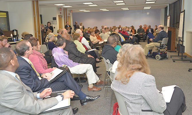 A representative from Reston Accessibility Committee presents remarks to crowd at Reston Community Center at the organization's meeting to discuss future needs and development.
