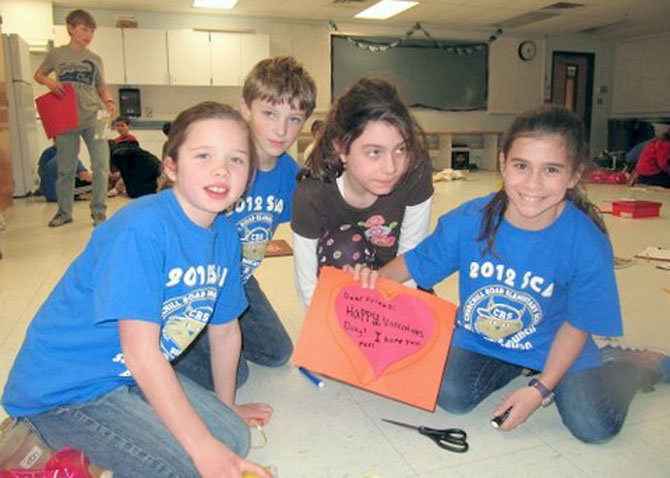 Churchill Road Student Council representatives Liliana Schone, Connor Farah, Catie Williams and Alexandra Bair create a Valentine’s card to go with the care package they made for a pediatric patient at INOVA Fairfax Children’s Hospital.
