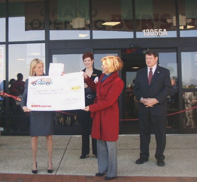 Cathy Poulin, Bob's Discount Furniture public relations director, presented a $1,000 donation to Jayne Shedd, director of development for the Congressional Schools of Virginia, at the Fairfax store opening. Also pictured are Colleen Wood, Bob’s Discount Furniture area manager and acting store manager for the new Fairfax store, and Supervisor Pat Harrity (R-Springfield).
