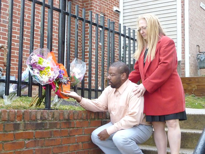 Marshall Love and Melinda Sigal pay their respects at the scene where Taft Sellers was killed in an Alexandria police-related shooting Feb. 18. Both witnessed the incident from across Duke Street.