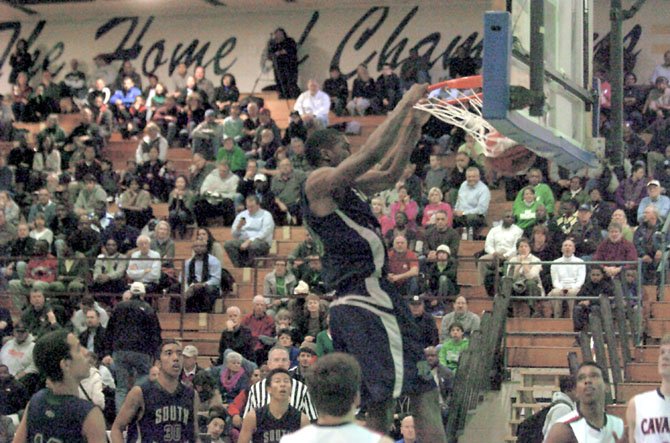 South County senior Oren Burks dunks against Woodson in the Northern Region tournament semifinals on Feb. 22 at Robinson Secondary School.