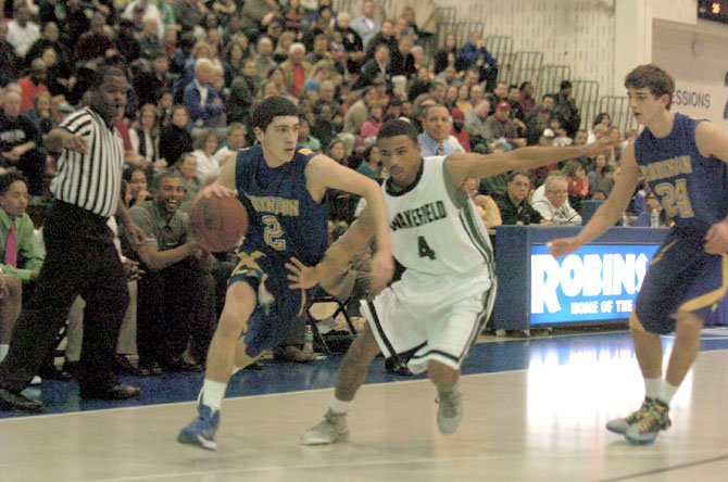 Robinson’s Matt Fall, left, dribbles against Wakefield’s Khory Moore in the Northern Region semifinals on Feb. 22.