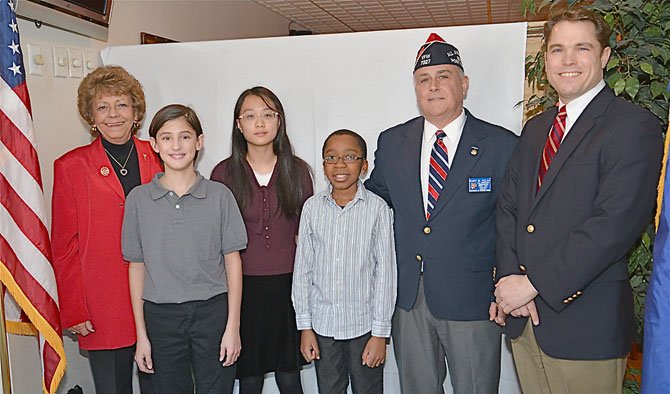 VFW Post 7327 Ladies Auxiliary President Linda Bond, Patriot's Pen Award first place winner Shane King, second place winner Sion Kim, third place winner Rishon Elliott, Post Commander Gary Kelch and Michael Collins, from Congressman Gerry Connolly's office. The winners were all sixth grade classmates from Keene Mill Elementary.
