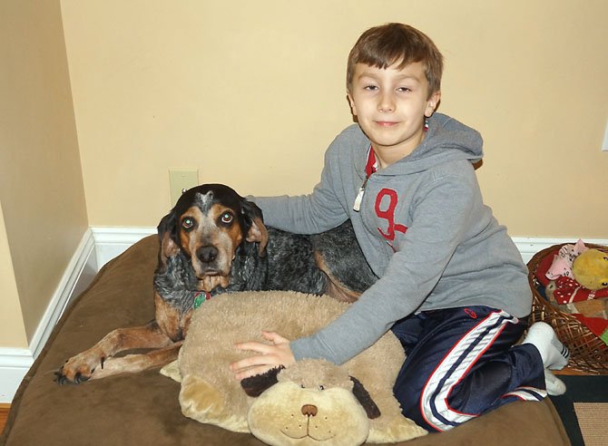 Jonathan Fernandez of Burke area cuddles and poses with Kristy, who the family adopted in July of 2007.
