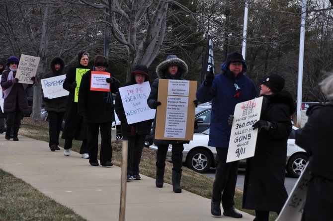 Members of the Reston-Herndon Alliance to End Gun Violence march in front of the National Rifle Association Headquarters Friday, Feb. 22. 