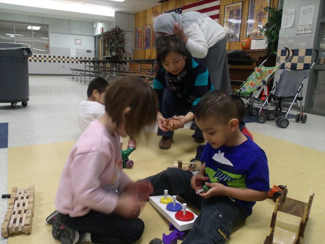 Preschool children of Forest Edge Elementary School playing with donated toys by the RCC’s Good Neighbor woodworking group.