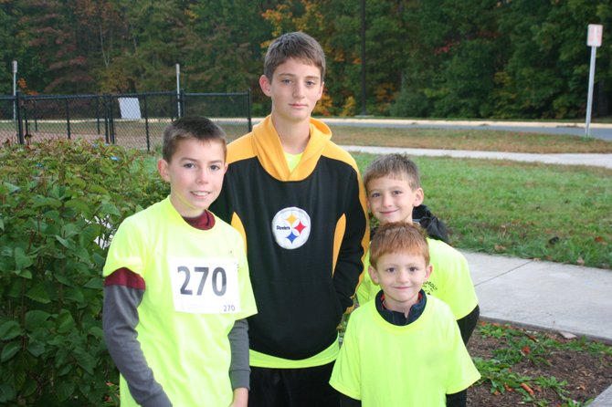 Youth look forward to the color misting at this year’s Color Fun Run for Technology at Halley Elementary. From left: Zach Burcher, Will Ardrey, Chris Ardrey and Michael Ardrey after finishing last year's race. 
