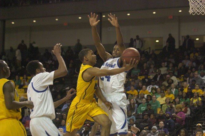Wakefield senior Khory Moore drives to the basket against John Marshall in the AAA state semifinals on Monday night at VCU’s Siegel Center in Richmond.