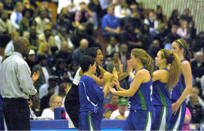 South Lakes girls’ basketball coach Christy Winters-Scott encourages members of the team during the state quarterfinals on March 1 at Robinson Secondary School.